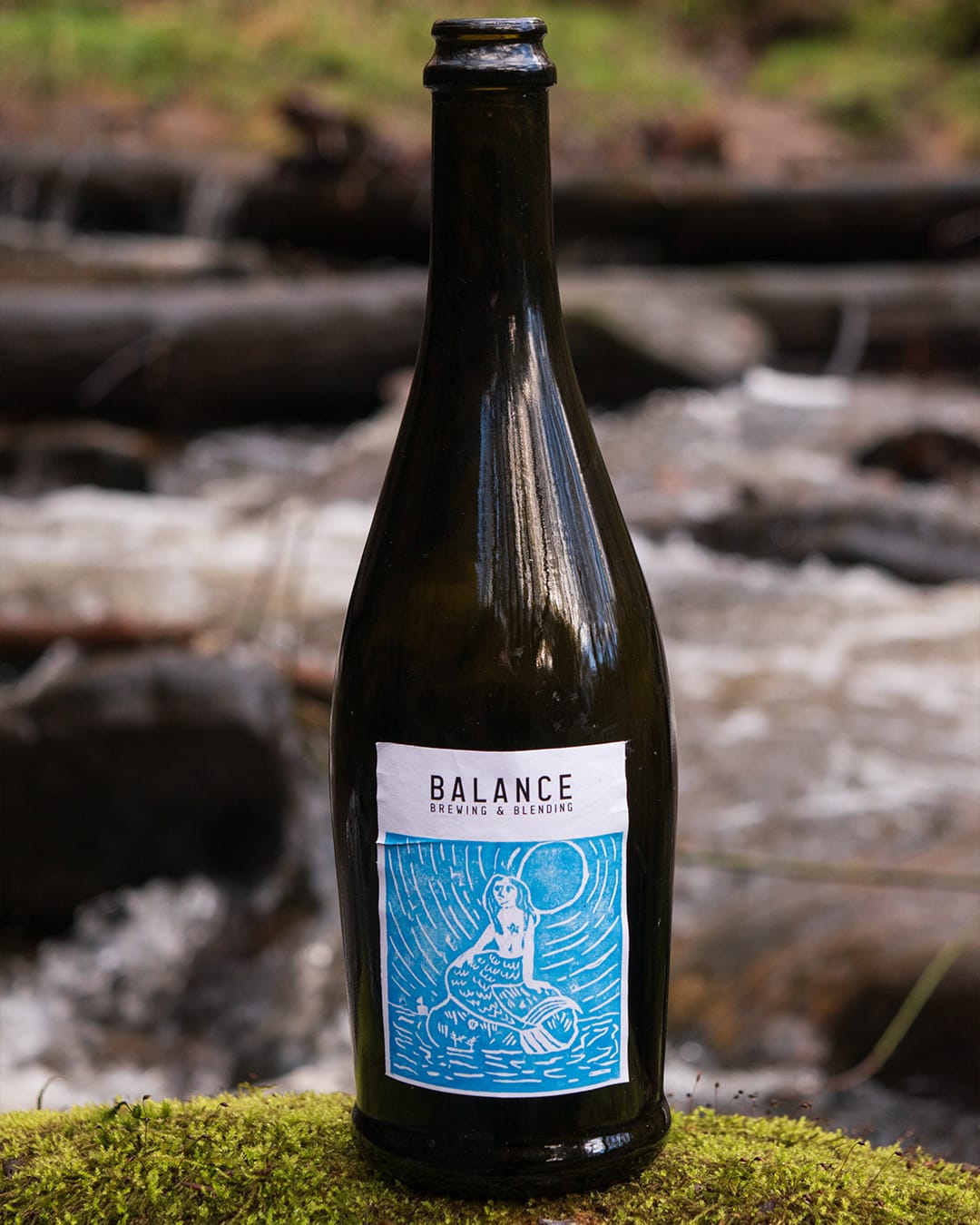 Mermaid lino print label design — mythological figure hand-carved for craft brewery branding